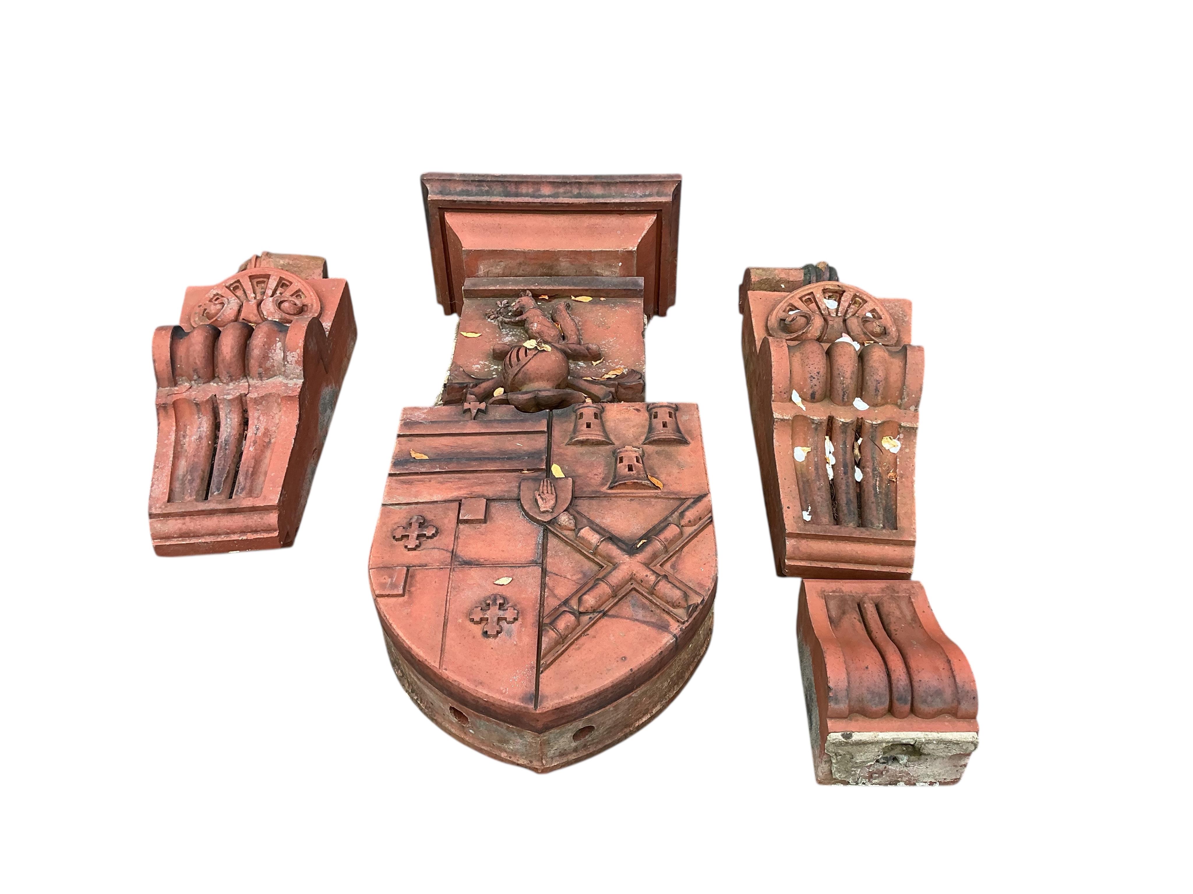 A Victorian terracotta country house armorial plaque, height 150cm with serpentine scroll corbels